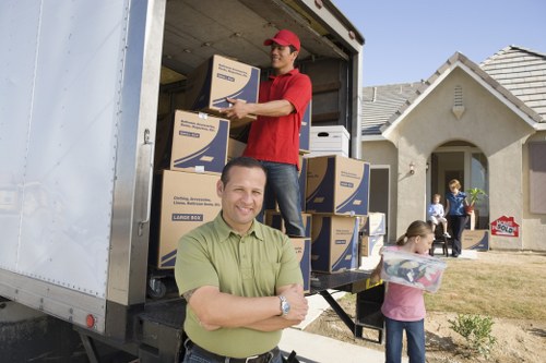 Professional movers handling furniture in a Slade Green home