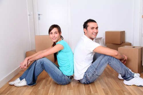Customers loading boxes and furniture into a hire truck
