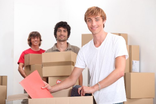 Unpacking assistance helping a family settle into a new Slade Green home