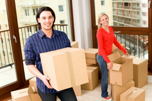 Professional movers handling office furniture and equipment